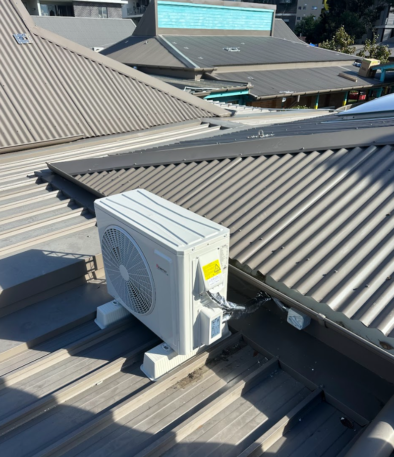 Daikin heat pump unit on brick wall